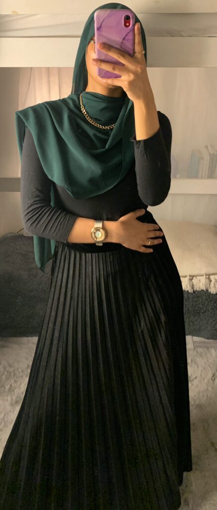 pop of dark green with black themed modest outfit
