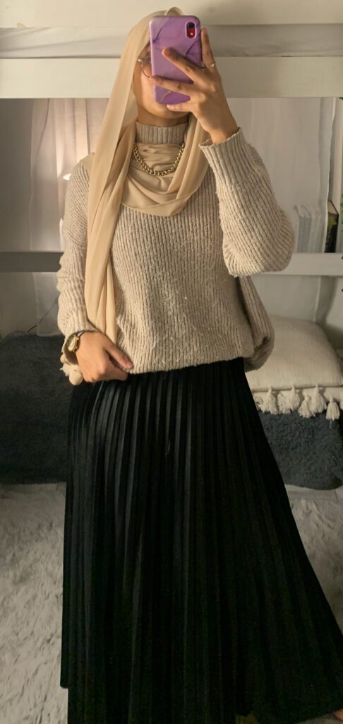 a hijabi wearing jumper and skirt modest outfit look