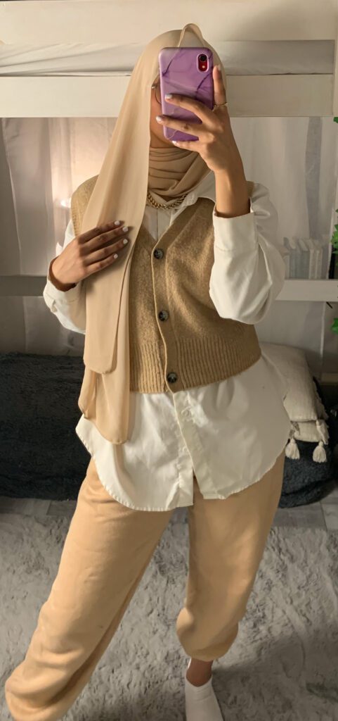 beige hijab with a white shirt and sweater vest and matching beige joggers